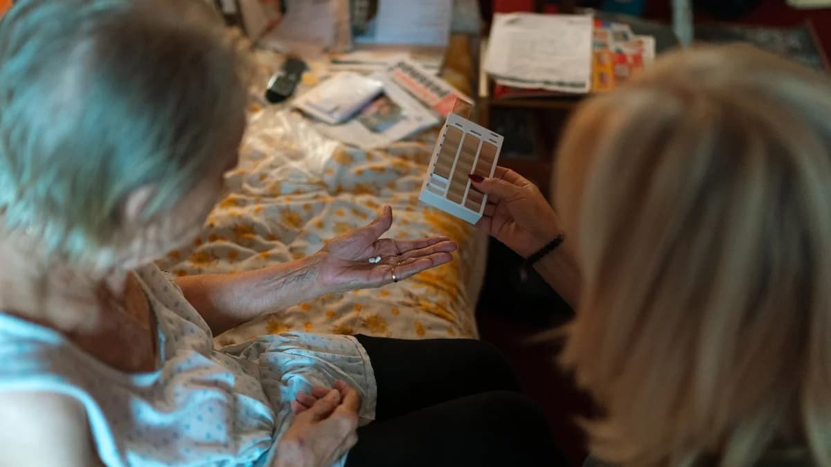 Caregiver helping a stroke survivor manage medication after hospital discharge
